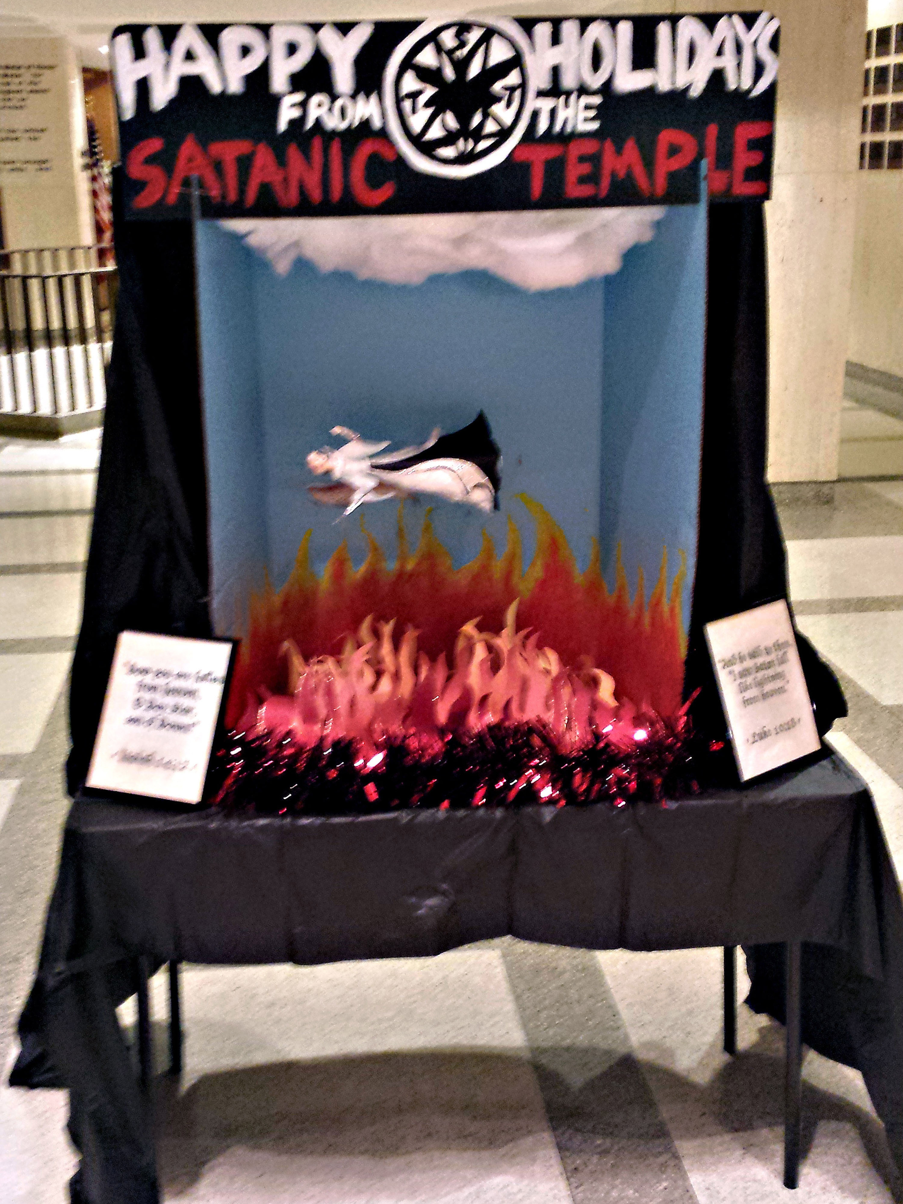 The Satanic Temple holiday display at the Florida Capitol on Monday — before it was vandalized. (TNS /Landov)