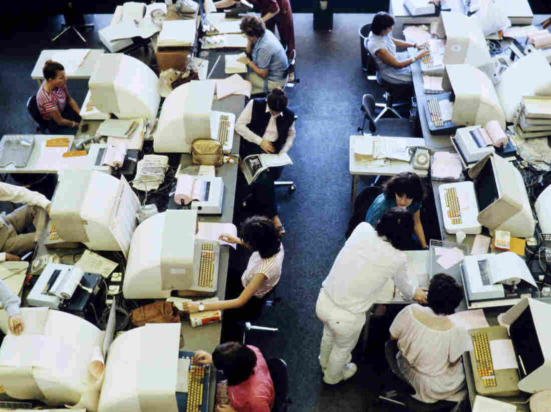 Journalists are seen working on computers in the press room of French press agency Agence France-Presse.