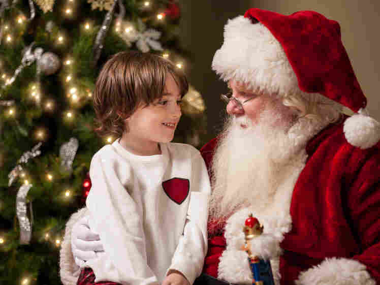 A young boy with Santa Claus.