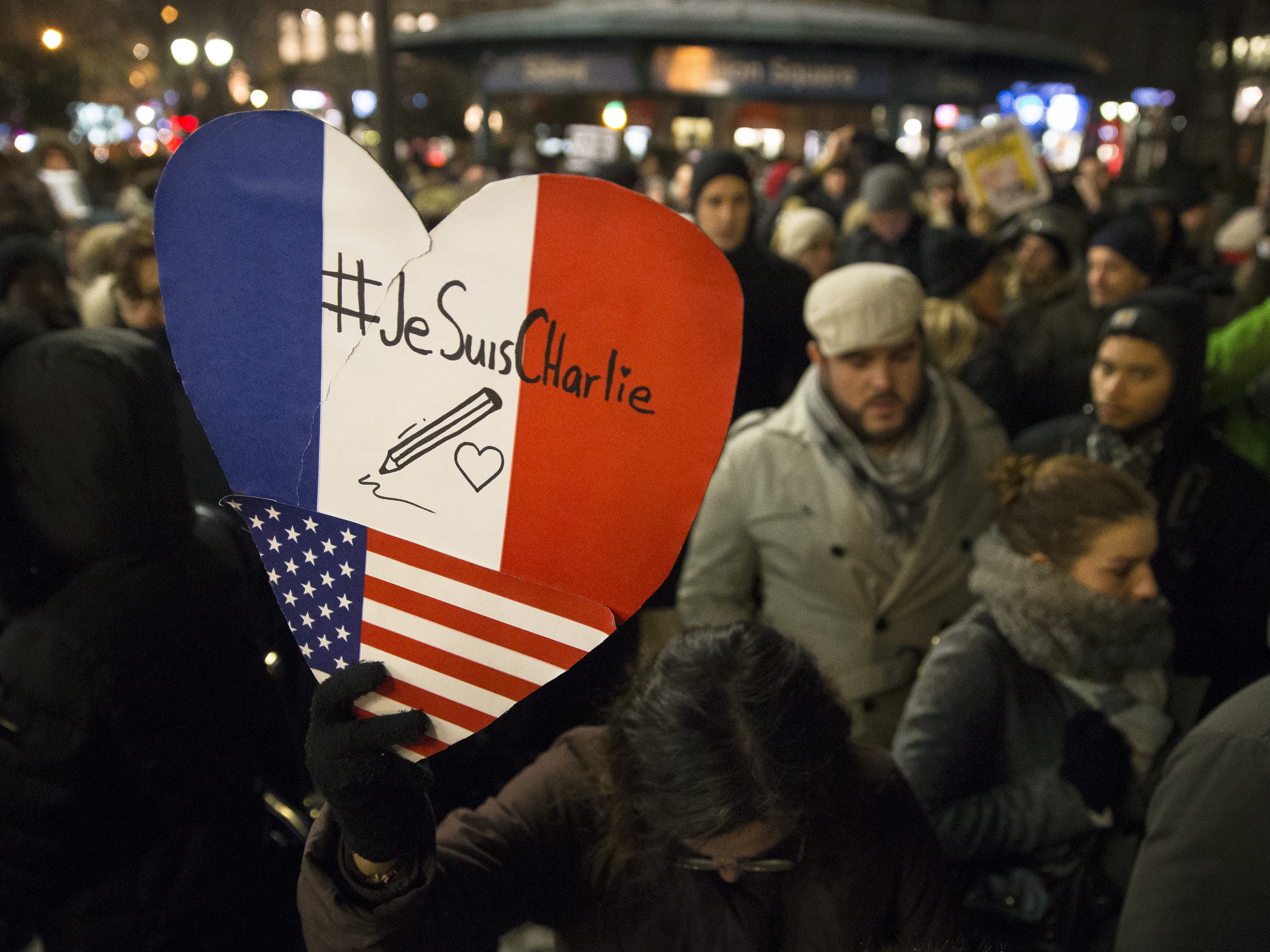 Mourners attend a rally Wednesday night at Union Square in New York City in support of Charlie Hebdo, a French satirical weekly newspaper that fell victim to a deadly terrorist attack earlier in the day.