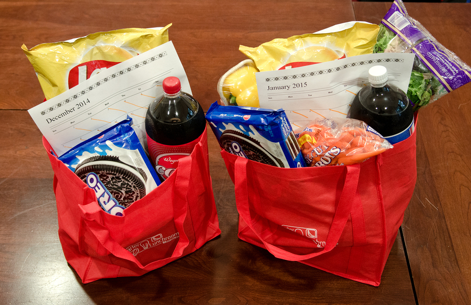 Researchers created the bag on the left as an example of groceries bought in December while those on the right show groceries bought in January. After the New Year, some shoppers add healthier items to their carts but end up taking home more calories than they do during the holidays, a study found. (Robyn Wishna/Cornell University)
