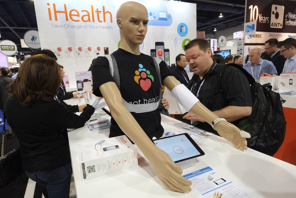 Visitors check out wireless blood pressure monitors at the Consumer Electronics Show in Los Angeles. (Joe Klamar/AFP/Getty Images)