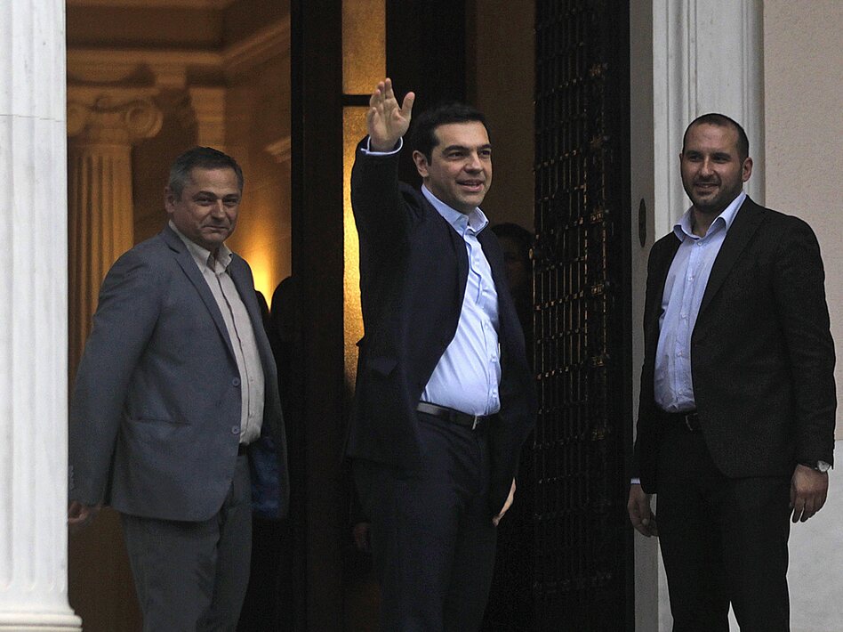 Newly sworn-in Greek Prime Minister Alexis Tsipras enters his new offices in Athens on Monday. (Orestis Panagiotou/EPA/Landov)