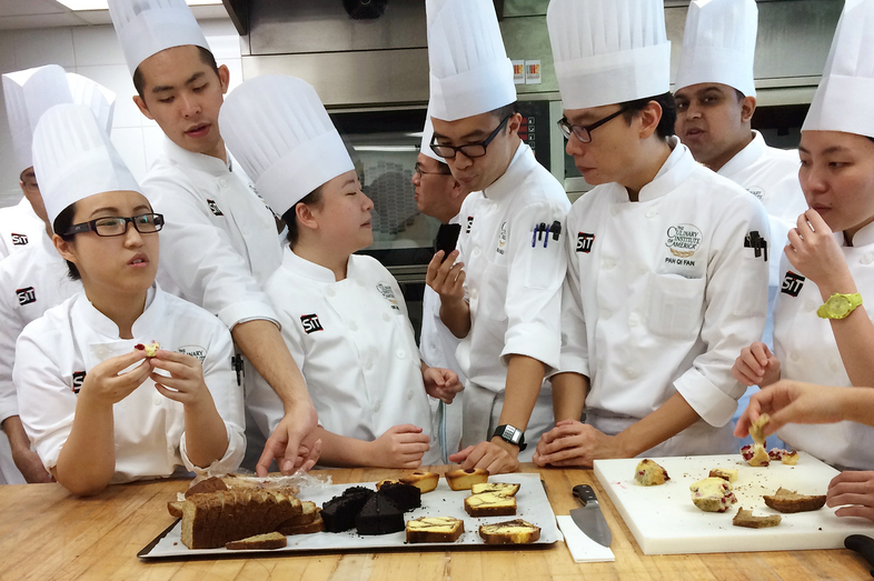 Students sample the results of their labors in Yvonne Ruperti's pastry class at the Culinary Institute of America's Singapore branch. (Carole Zimmer)