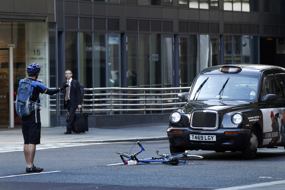 A cyclist reacts after coming off his bike in an incident with a taxi in London in 2011. (Matt Dunham/AP)