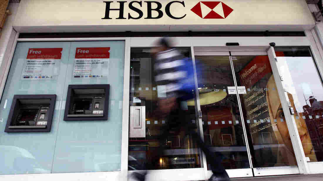 A pedestrian passes a branch of HSBC bank in London.