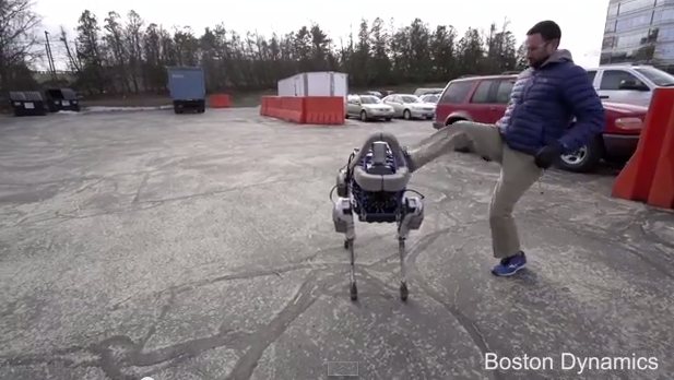 A Boston Dynamics robot called Spot is kicked by a human. (Boston Dynamics via YouTube)