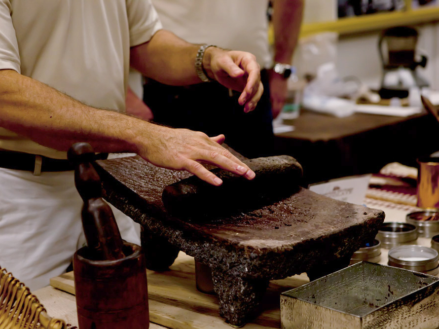 A Mars Inc. employee demonstrates how cacao beans are ground into cocoa powder at a chocolate-making demonstration at the National Archives.