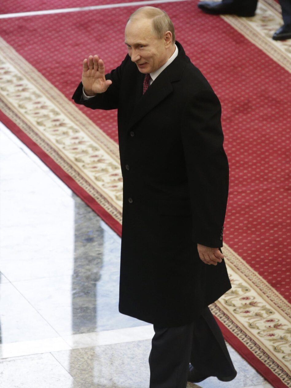 Russian President Vladimir Putin waves as he leaves a Ukrainian crisis peace summit in Minsk, Belarus. After hours of talks, Russia and Ukraine reached a deal for a cease-fire in eastern Ukraine. (Tatyana Zenkovich/EPA/Landov)