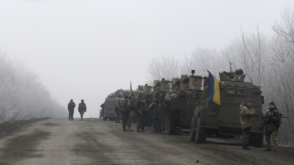 A Ukrainian military convoy stops on the road between the towns of Debaltseve and Artemivsk, Ukraine, on Saturday, hours before a cease-fire agreement is set to go into effect. (Petr David Josek/AP)