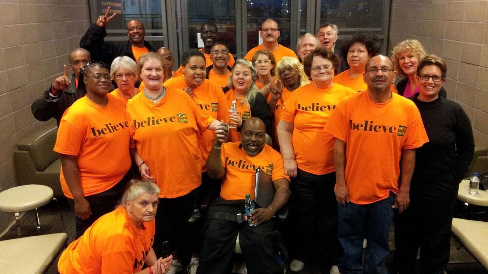 The Dallas Street Choir performed in T-shirts, then changed into formalwear for the <em>Street Requiem</em>. Baritone Russell Rodriguez is in front, far right, in an orange T-shirt. (Courtesy of Mark Mullaney)