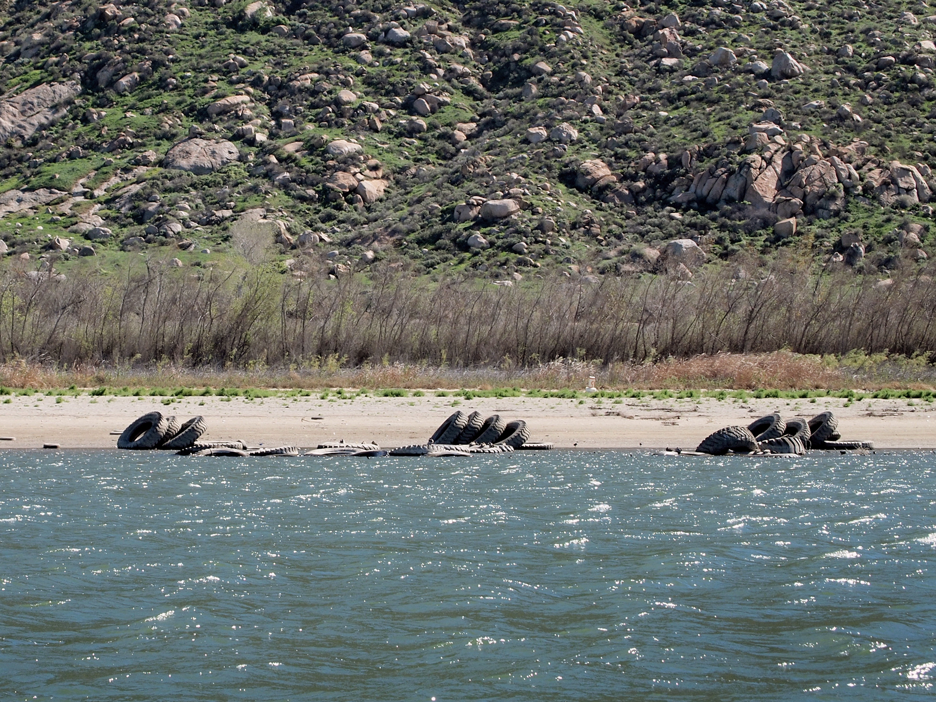 Last fall, the drought revealed dozens of large tractor tires that had been submerged under the water of Lake Perris. The "tire reef" had been placed under the water in the 1970s as a fish habitat.
