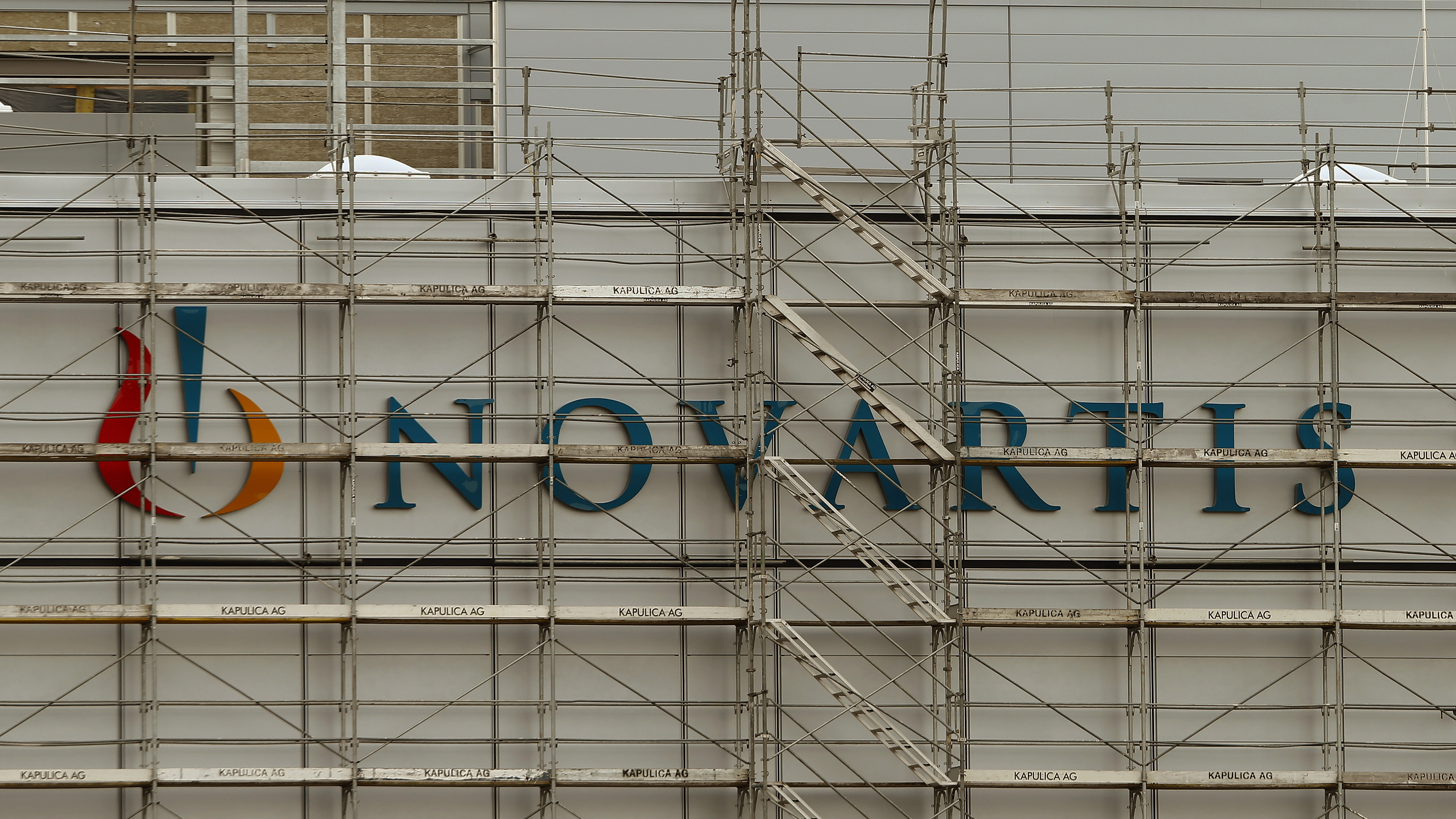 Swiss drugmaker Novartis' logo is seen behind scaffolding at the company's plant in the northern Swiss town of Stein, shown in January. The company's "biosimilar" drug Zarxio has received FDA approval.
