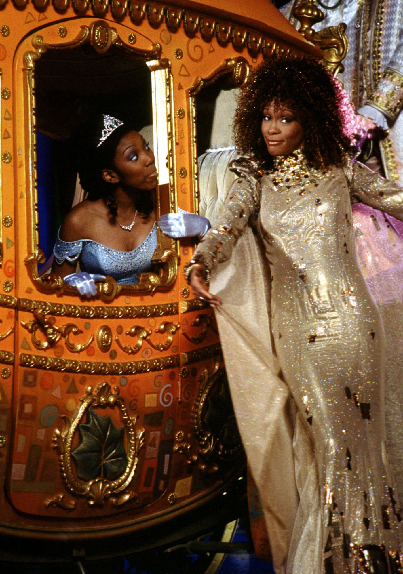Brandy Norwood and Whitney Houston pose with the coach from their version of Cinderella.