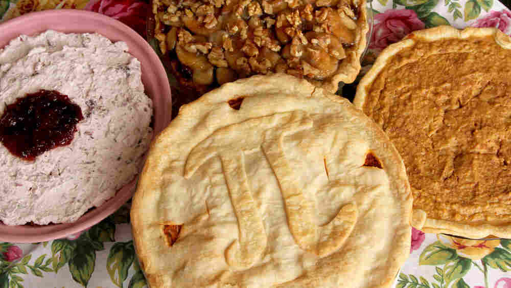 Four pies on a floral tablecloth