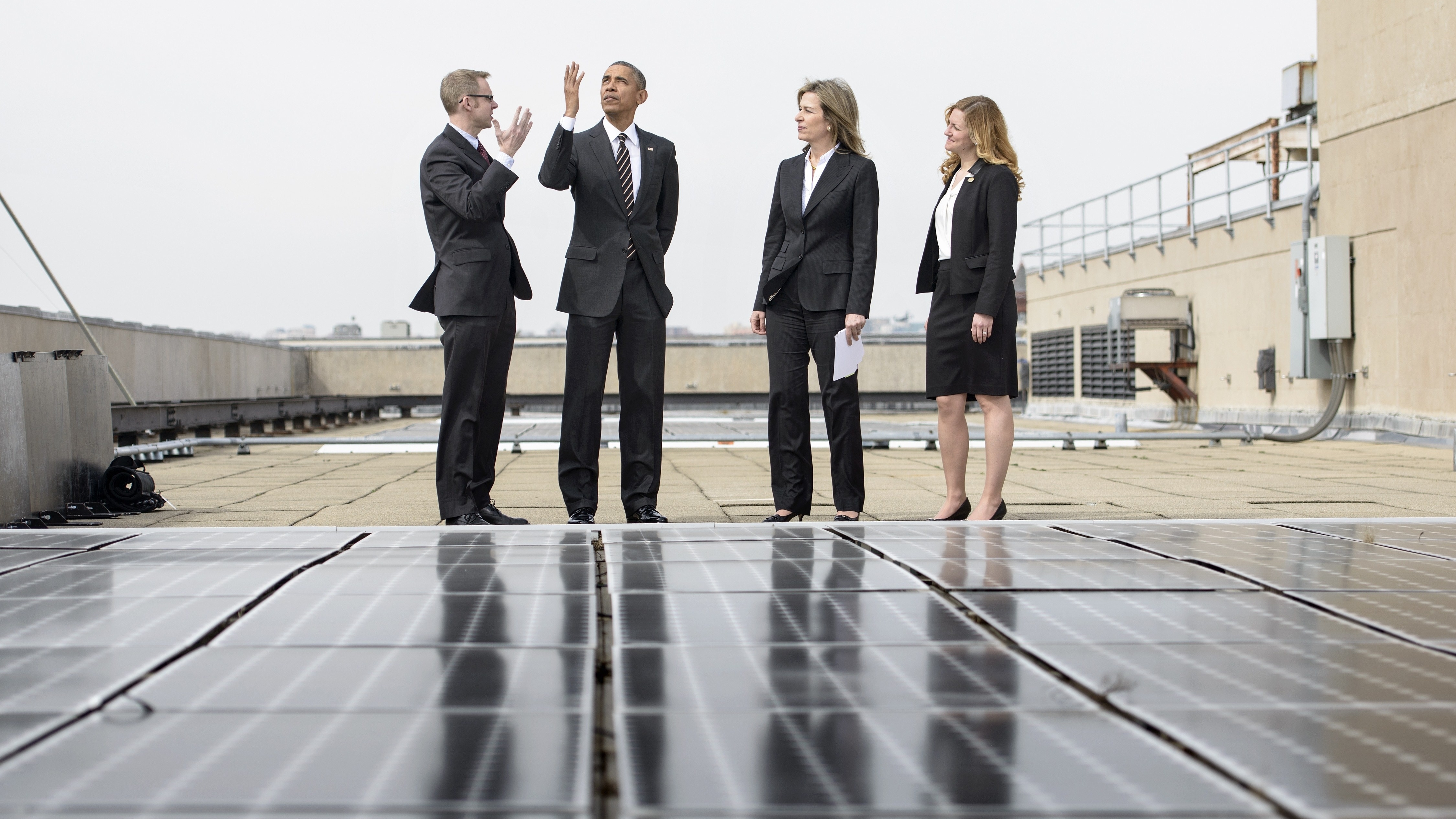 President Obama views solar panels on the roof of the Department of Energy with Deputy Secretary Liz Sherwood-Randall, second from right, Federal Chief Sustainability Officer Kate Brandt, right, and Energy Manager Eric Haukdal, left. (AFP/Getty Images)