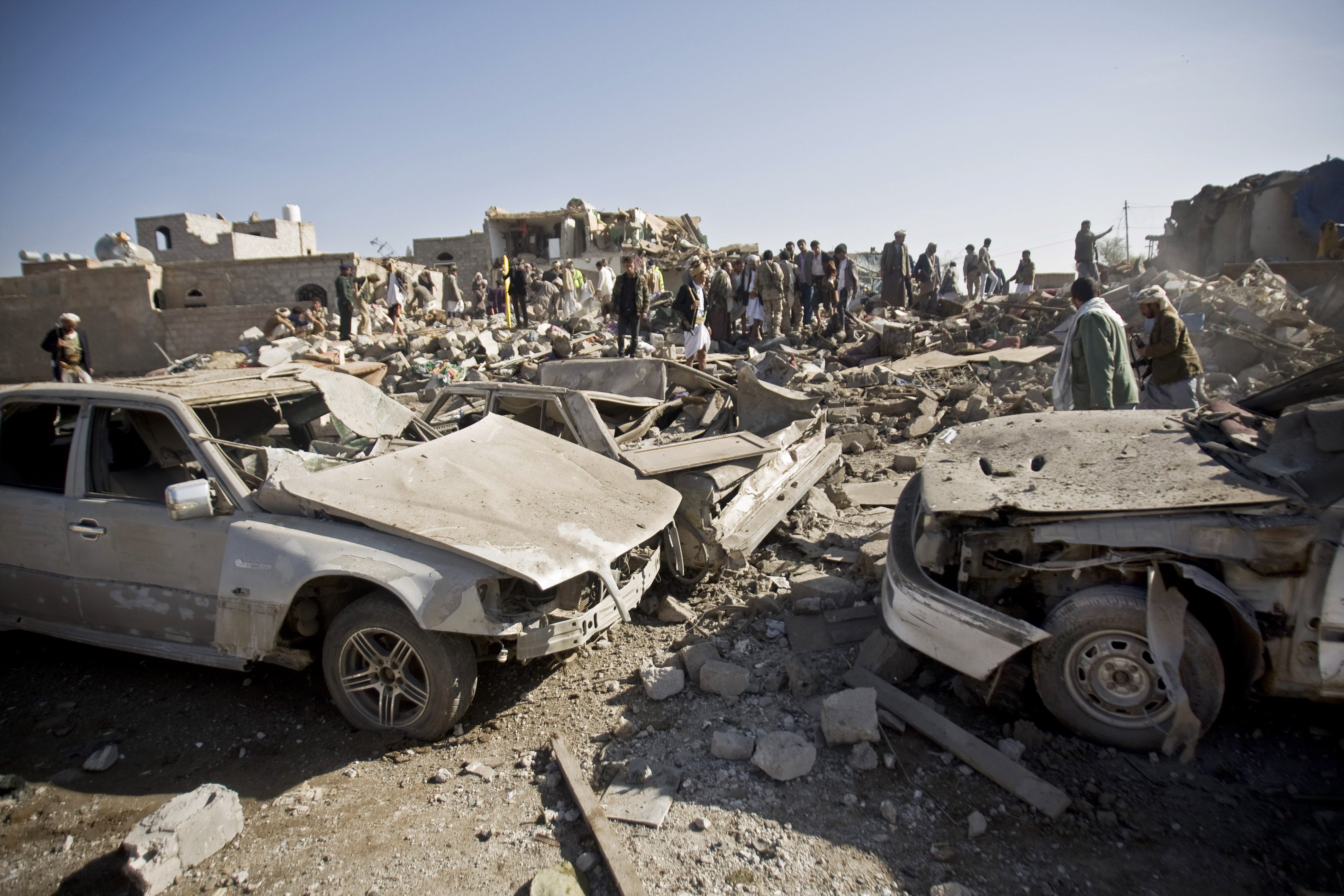 People search for survivors under the rubble of houses destroyed by Saudi airstrikes near Sanaa Airport, Yemen, on Thursday.