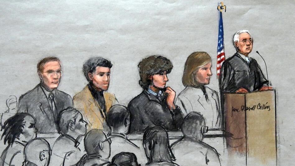 In this courtroom sketch, Boston Marathon bombing suspect Dzhokhar Tsarnaev (third from right) is depicted with his lawyers and U.S. District Judge George O'Toole Jr. (right) as O'Toole addresses a pool of potential jurors in a jury assembly room at the federal courthouse in January. The jury started deliberating Phase 1 of the trial on Tuesday. (Jane Flavell Collins/AP)
