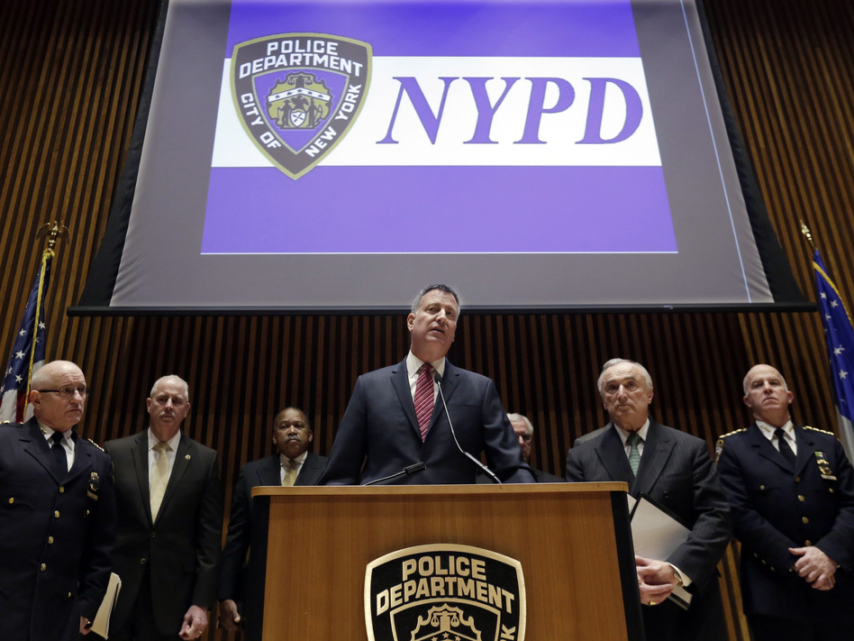 New York Mayor Bill de Blasio (center), City Police Commissioner William Bratton (second from right) and other NYPD officers address a news conference on Jan. 5. There is debate surrounding the citywide increase of low-level crime enforcement, otherwise known as the broken windows approach to policing.