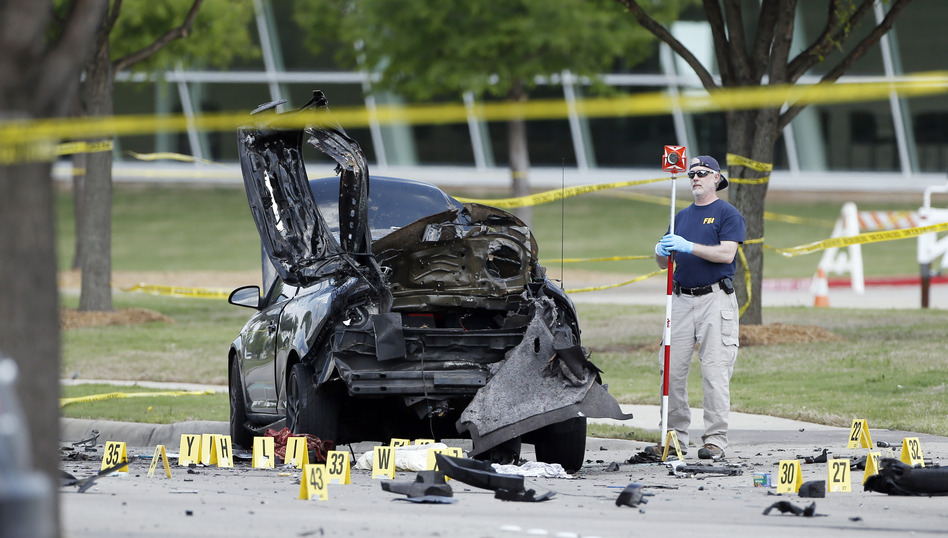 An FBI crime scene investigator documents evidence outside the Curtis Culwell Center on Monday in Garland, Texas. (Brandon Wade/AP)