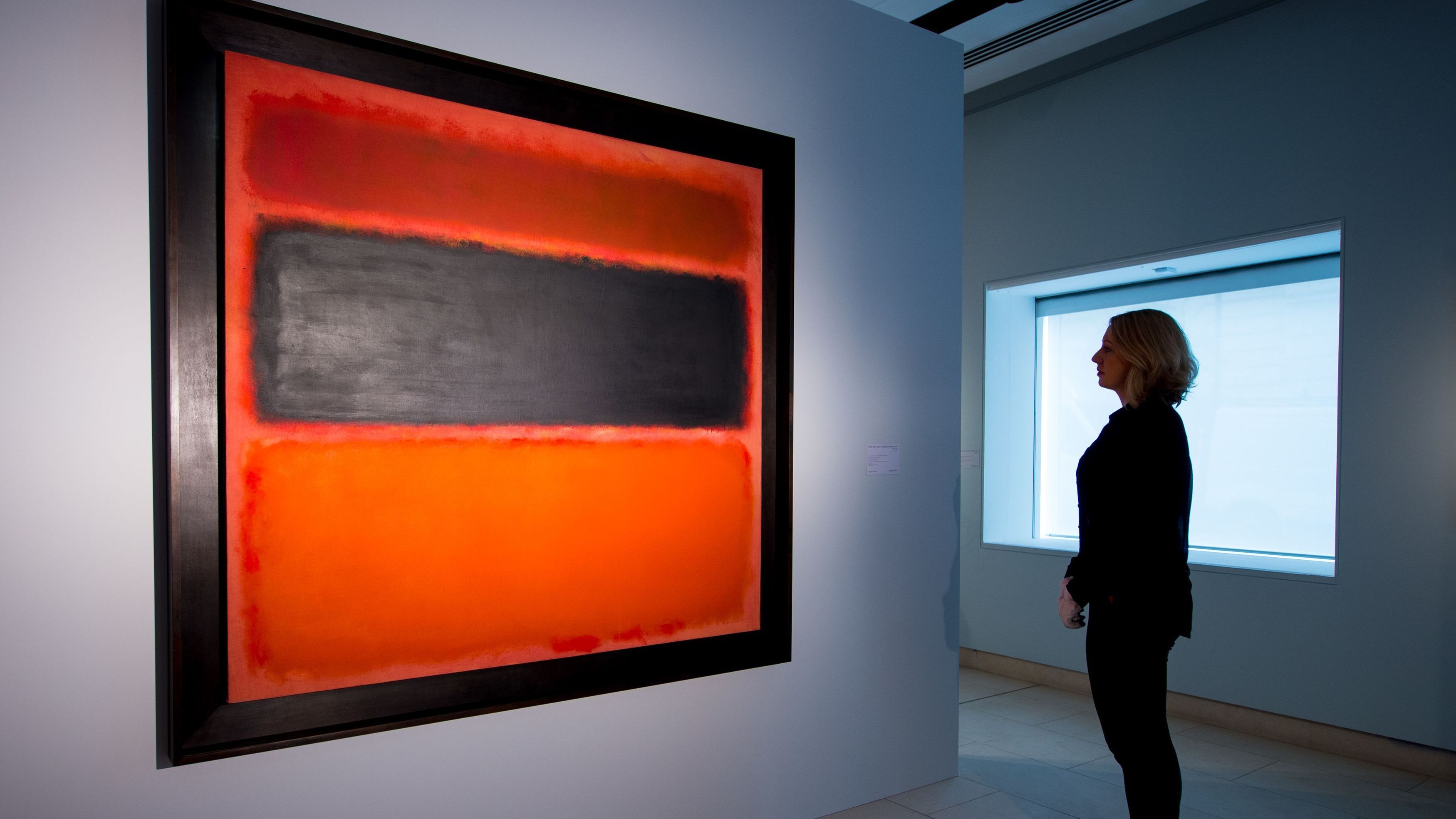 A visitor views at Christie's London showroom No. 36 (Black Stripe), a 1958 painting by Mark Rothko.