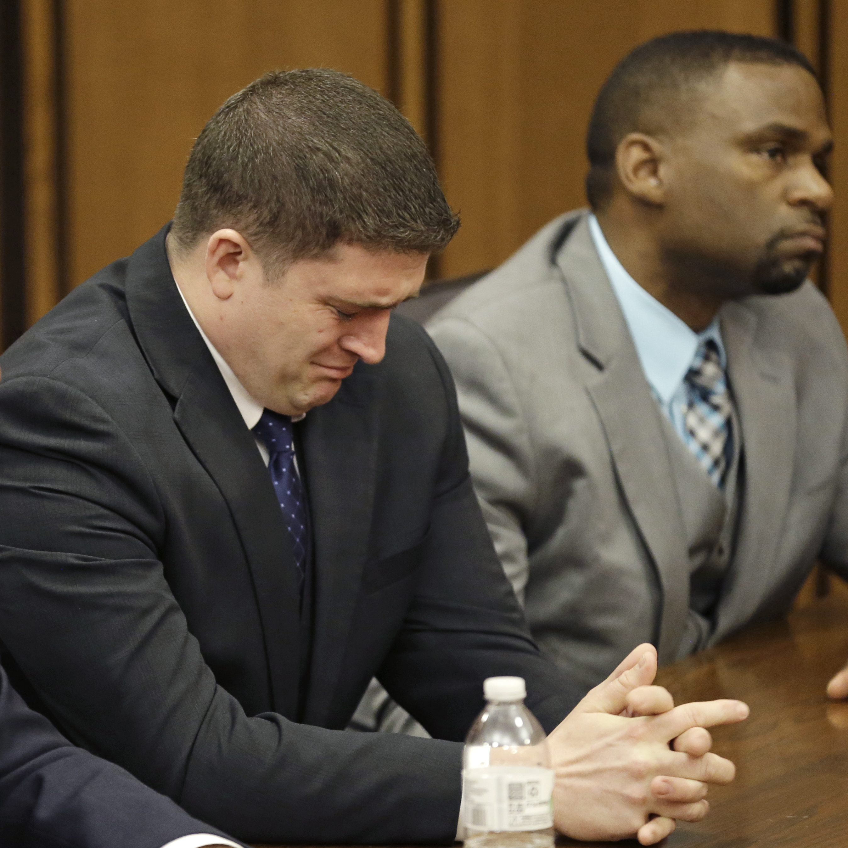 Michael Brelo weeps as he hears the verdict in his trial Saturday, in Cleveland. Brelo, a patrolman charged in the shooting deaths of two unarmed suspects during a 137-shot barrage of gunfire was acquitted.
