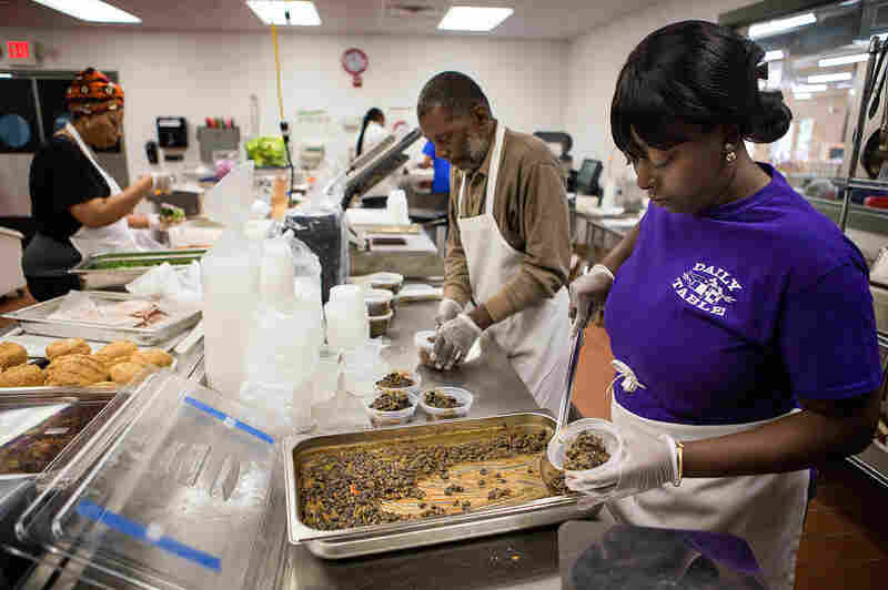 In the preparation kitchen, Marilyn Rush dispenses black beans into cups ready to be packed and sent out for retail.