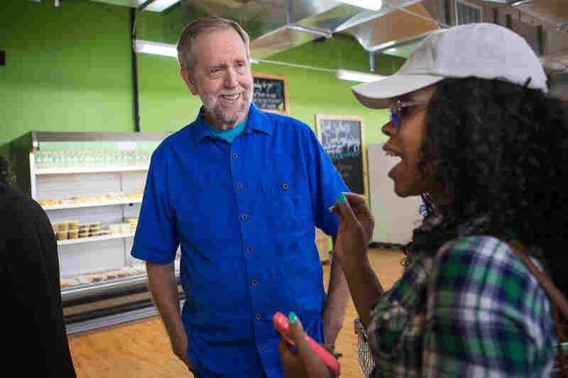 Daily Table founder Doug Rauch greets customer Latoya Rush after she walks into the store.