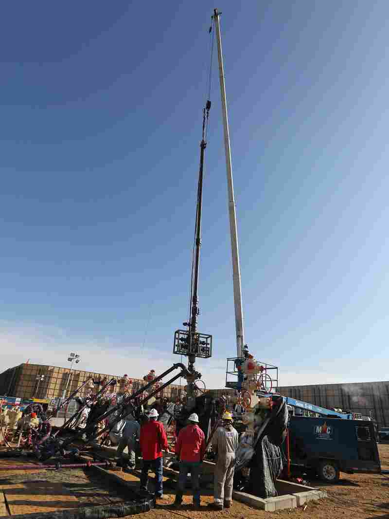 Workers use perforating tools to create fractures in rock. An EPA study finds that "fracking" to reach and extract deep pockets of hydrocarbons has not caused widespread drinking water pollution.