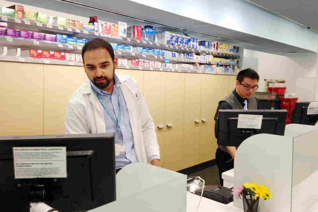 Amil Patel (left) and Bob Dunn run the front desk at this Walgreens pharmacy on the campus of the University of California, San Francisco. The store will be one of the first to take advantage of a new California law expanding pharmacists' scope of practice.