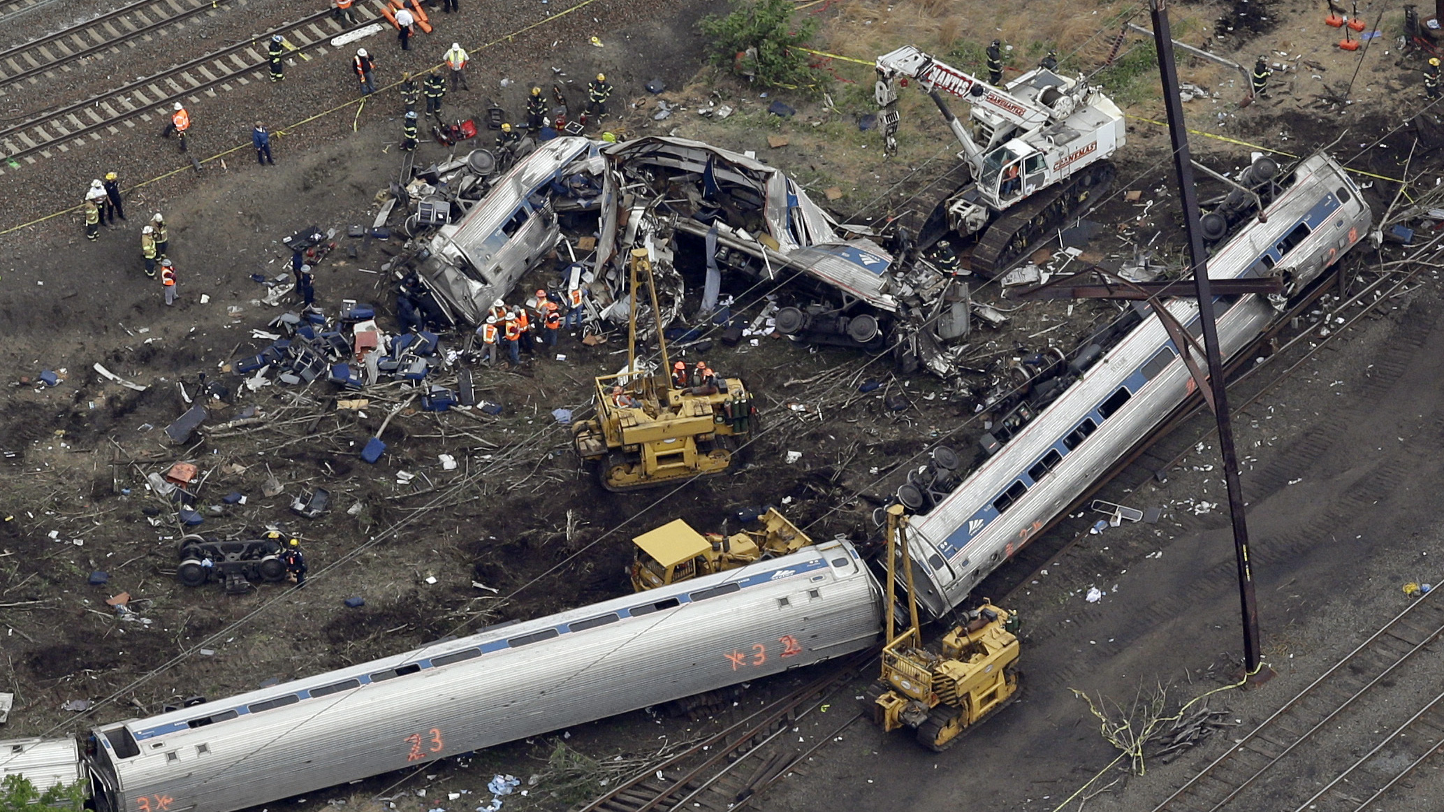 Emergency personnel work at the scene the day after a deadly train derailment on May 12 in Philadelphia.