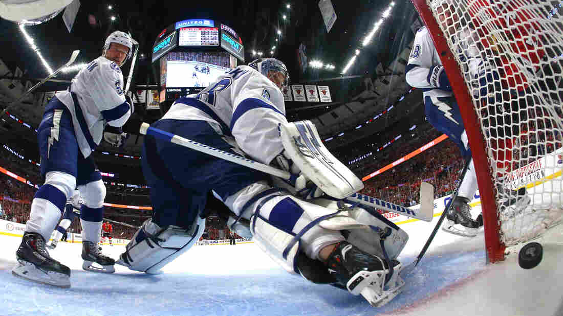 Anton Stralman, left, and Andrei Vasilevskiy of the Tampa Bay Lightning watch a shot by Jonathan Toews of the Chicago Blackhawks cross the line Wednesday night in the second period of Game Four of the Stanley Cup Finals in Chicago