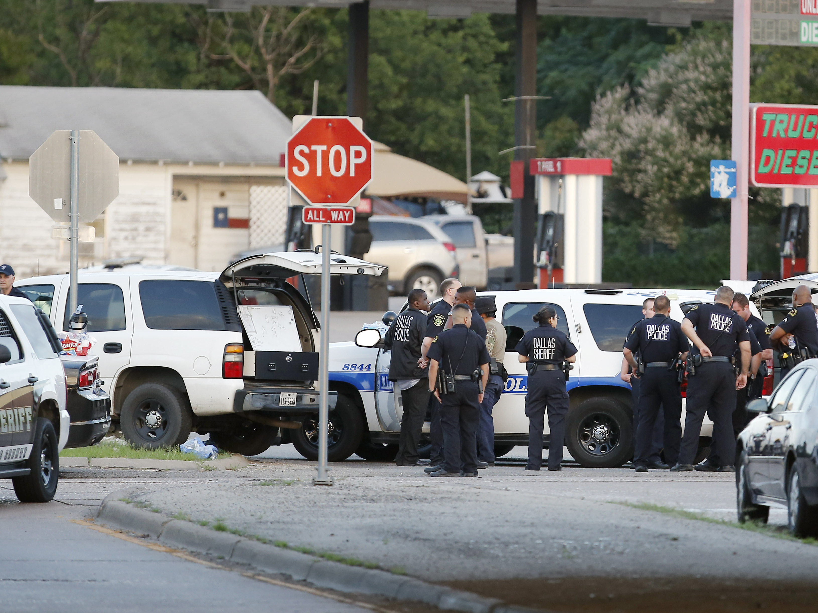 Police block the intersection of Dowdy Ferry Rd. and Interstate 45 during a standoff with a gunman barricaded inside a van in Hutchins, Texas.
