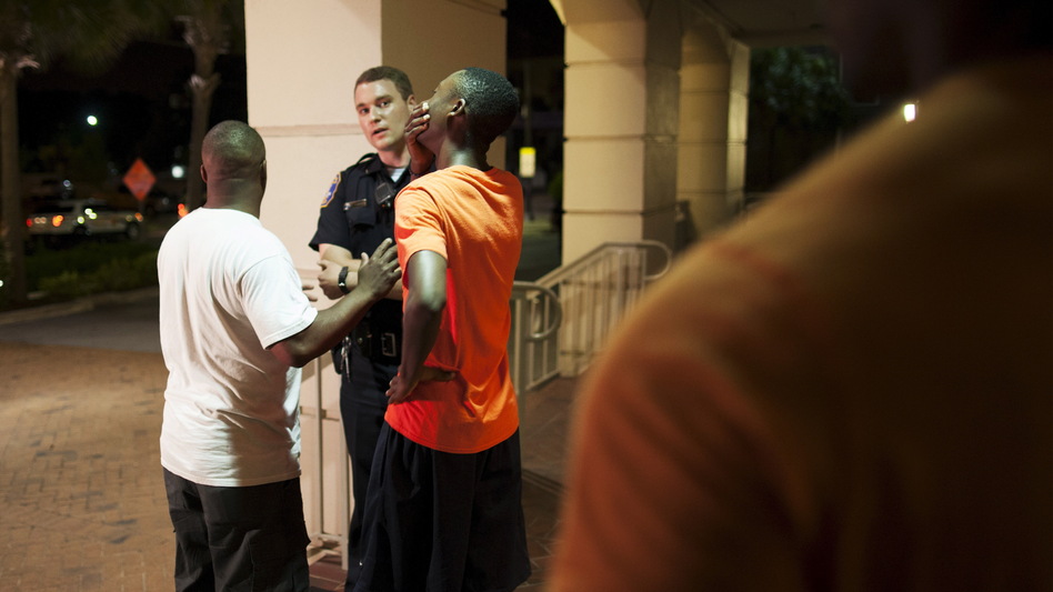 A man reacts while talking to police officer Wednesday night near the scene of shooting at the Emanuel AME Church in Charleston, S.C. (Randall Hill/Reuters/Landov)