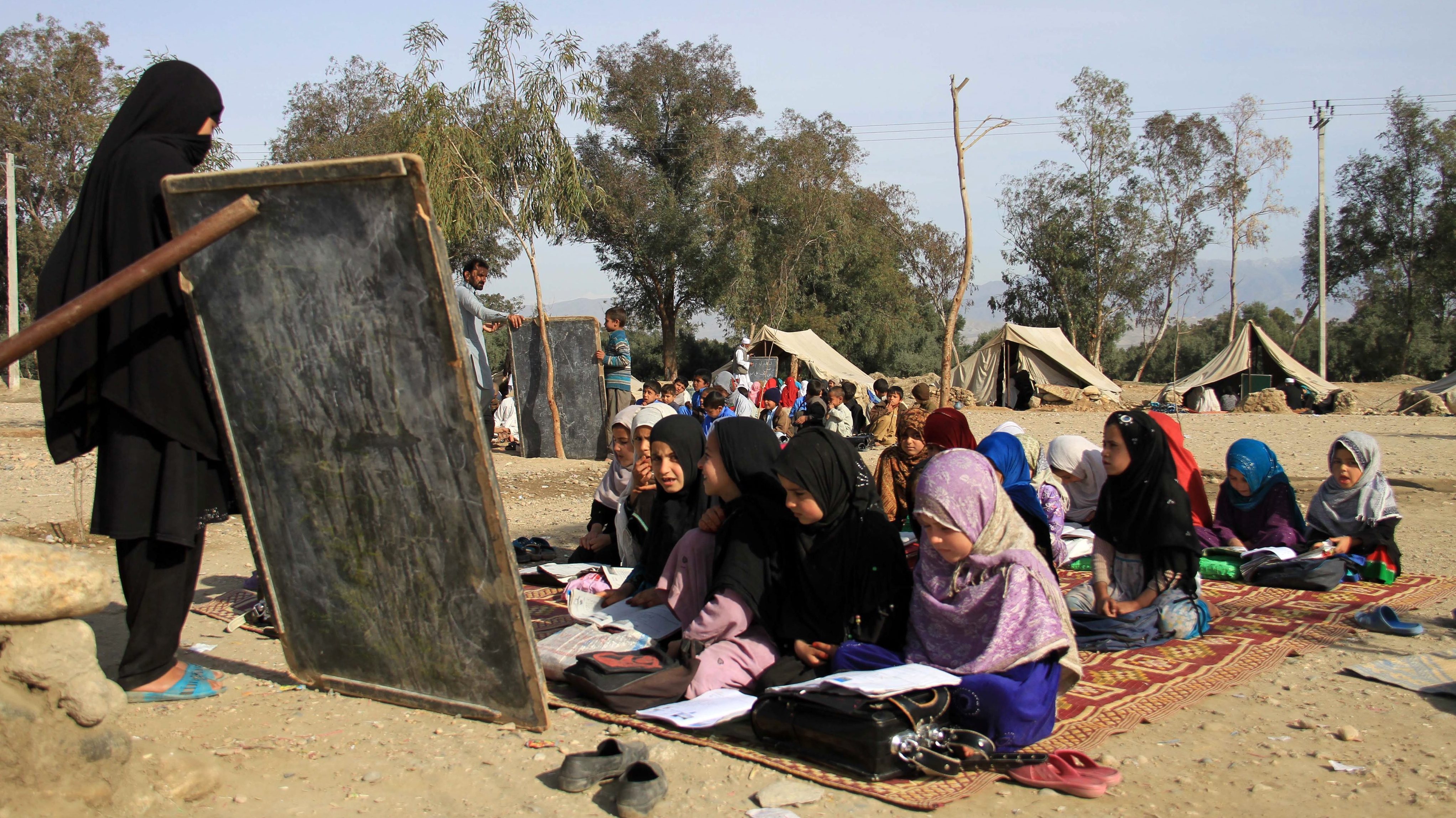 Afghan girls attend a makeshift school in the eastern city of Jalalabad in March. A sharp increase in students, particularly girls, is often cited as a success story in rebuilding the country. However, the U.S. special inspector for Afghanistan has questioned whether Afghan officials inflated the number of students enrolled.