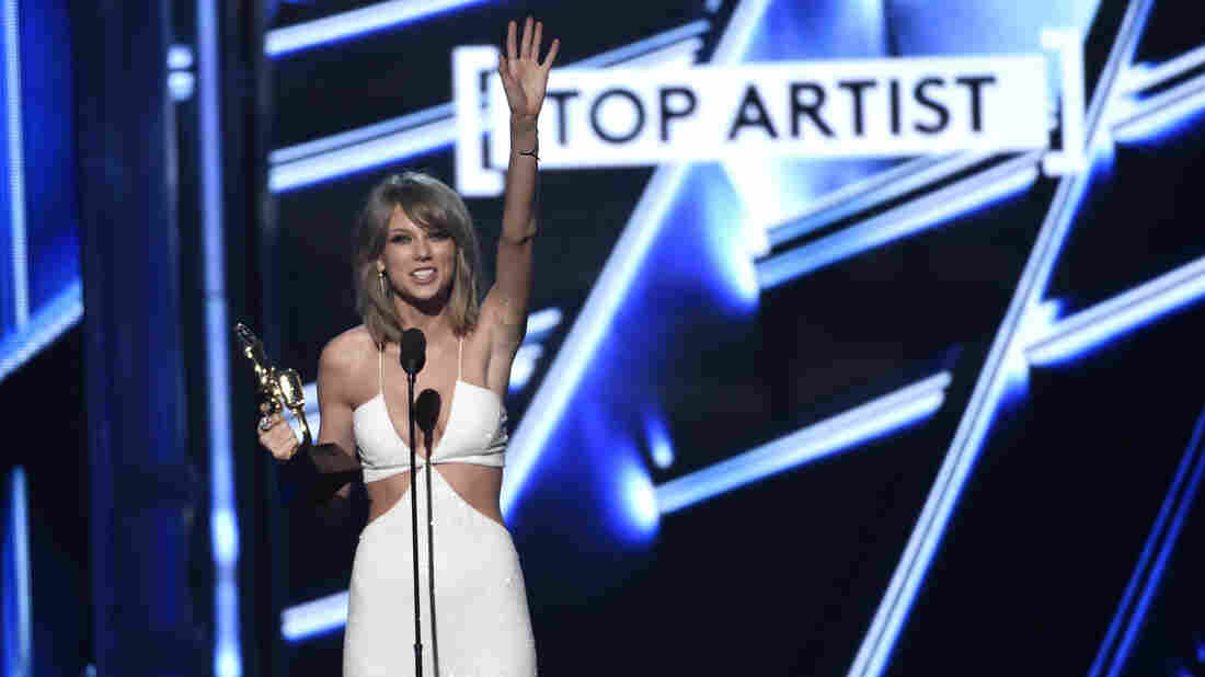 Taylor Swift accepts the award for top artist at the Billboard Music Awards. Swift's receiving the lion's share of credit for forcing Apple to pay artists to stream their music, even during a free trial period for users.