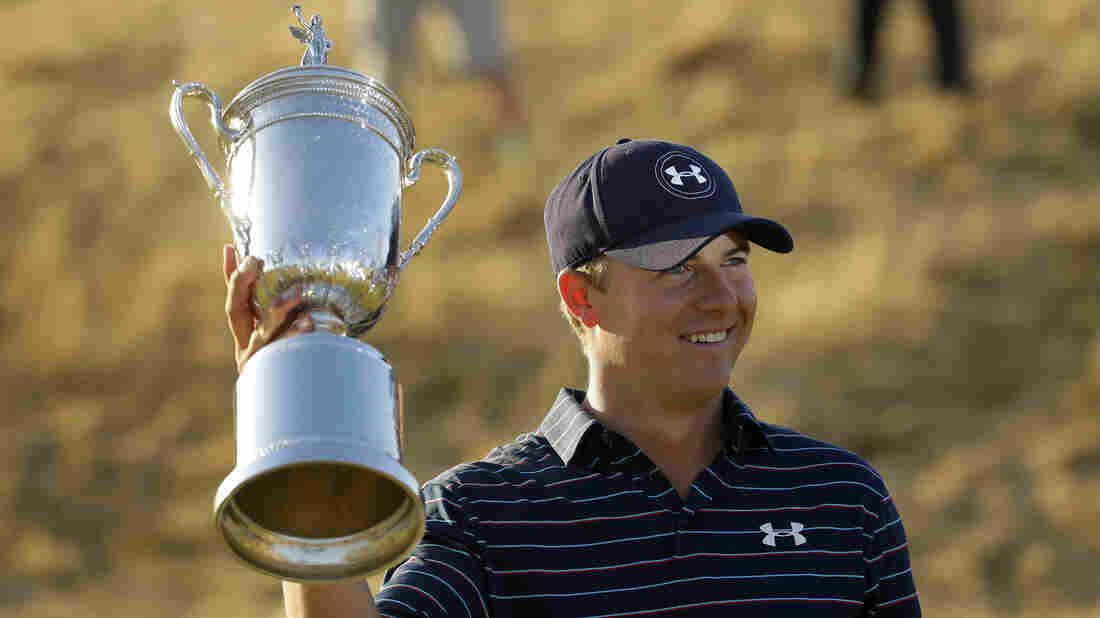 Jordan Spieth holds up the trophy after winning the U.S. Open golf tournament at Chambers Bay on Sunday in University Place, Wash.