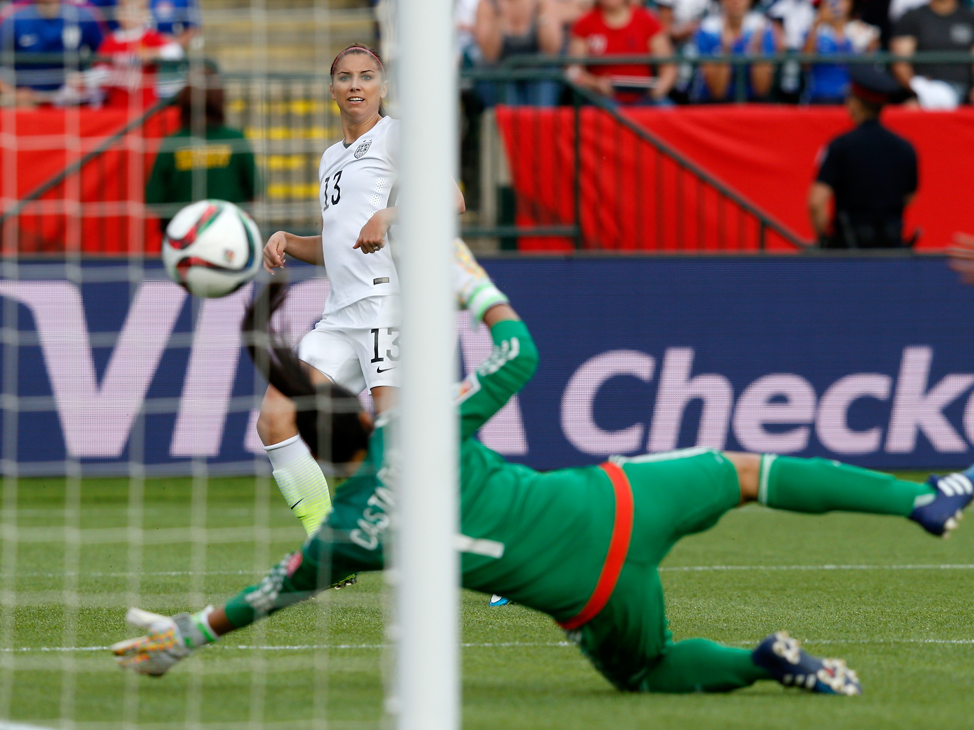 American forward Alex Morgan scores her first goal of this year's Women's World Cup on Monday against goalkeeper Stefany Castano of Colombia. The U.S. won the match 2-0.