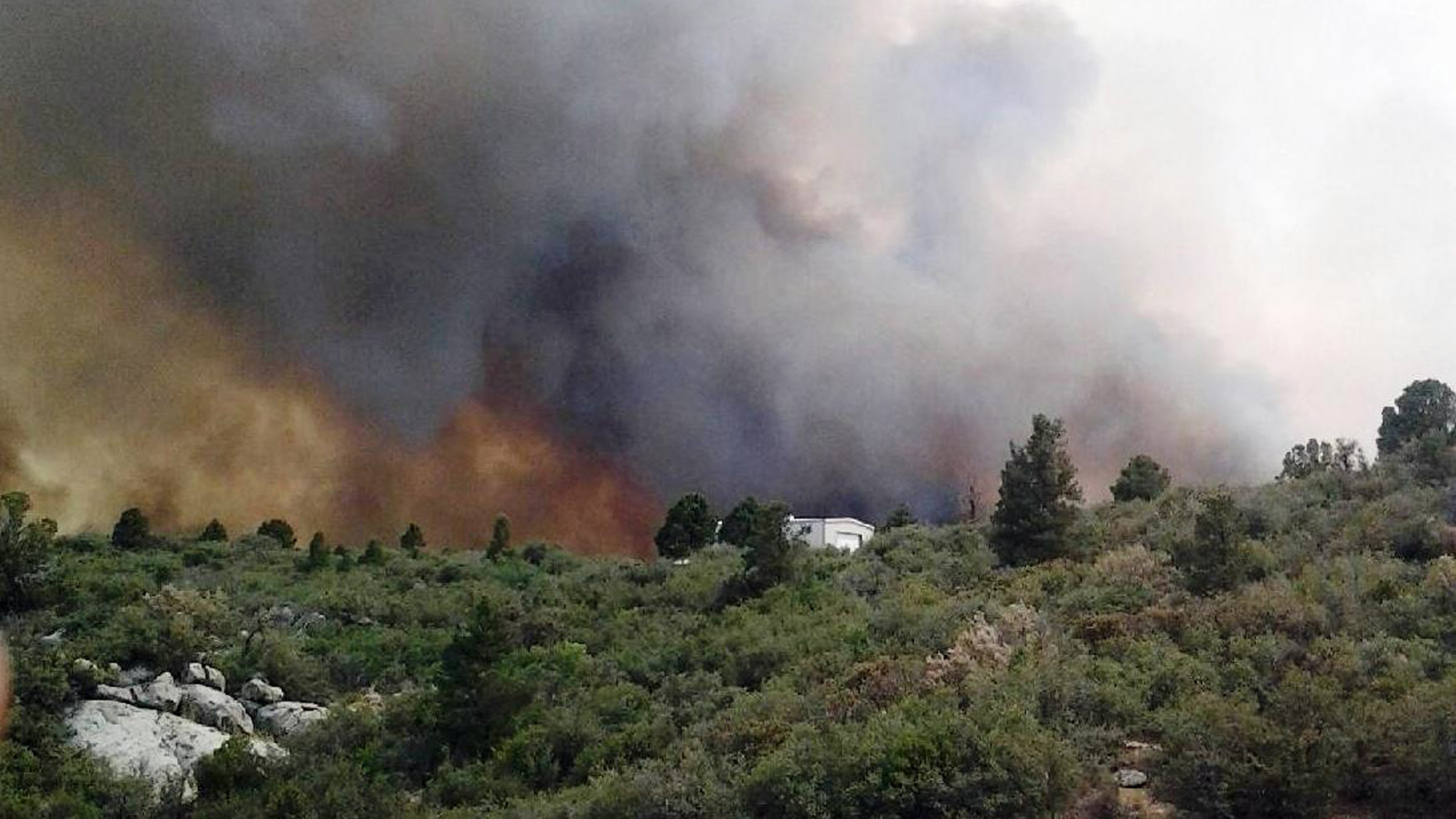An aerial view shows the Yarnell Hill fire burning June 29, 2013 near the town of Yarnell, Ariz. The next day, 19 firefighters died battling the blaze. (Getty Images)