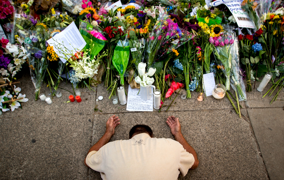 Raymond Smith of Charleston, S.C., kneels in prayer in front of the Emanuel AME Church in Charleston before a worship service on June 21. (Stephen B. Morton/AP)