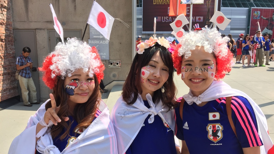 Japan fans are wildly outnumbered by red, white and blue ahead of the game on Sunday, but these three are decked out and ready to go. From left, Asuka Tsujimoto Keiko Tsujii and Yuri Nakayama came to Vancouver to cheer their country on. (Melissa Block/NPR)