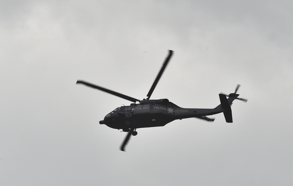 A federal police Black Hawk helicopter flies over a house at the end of a tunnel through which drug lord Joaquin "El Chapo" Guzman could have escaped from Mexico's Altiplano prison. (Yuri Cortez /AFP/Getty Images)
