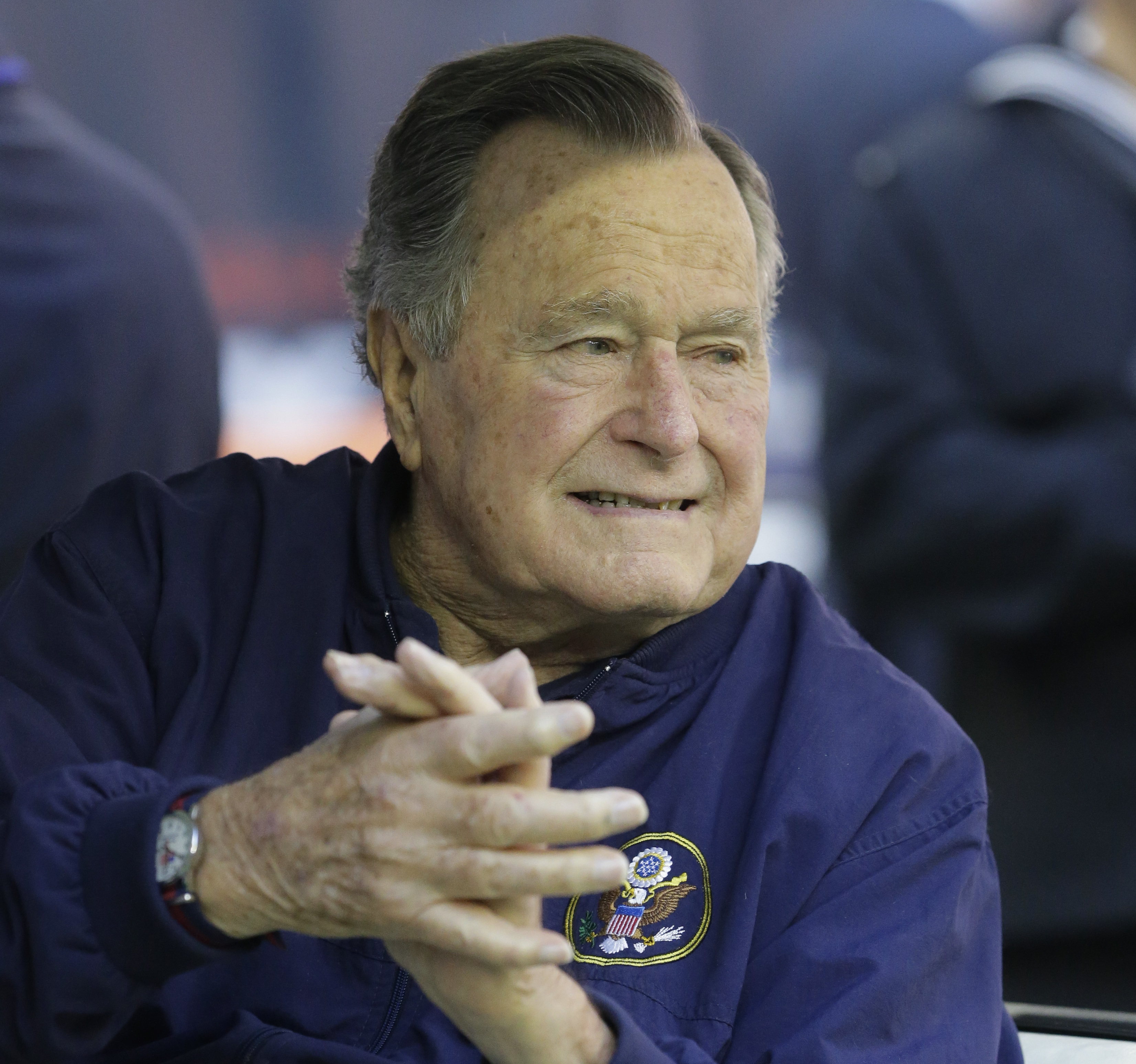 Former president George H. W. Bush attends an NFL football game between the Houston Texans and Cincinnati Bengals, in Nov. 2014.