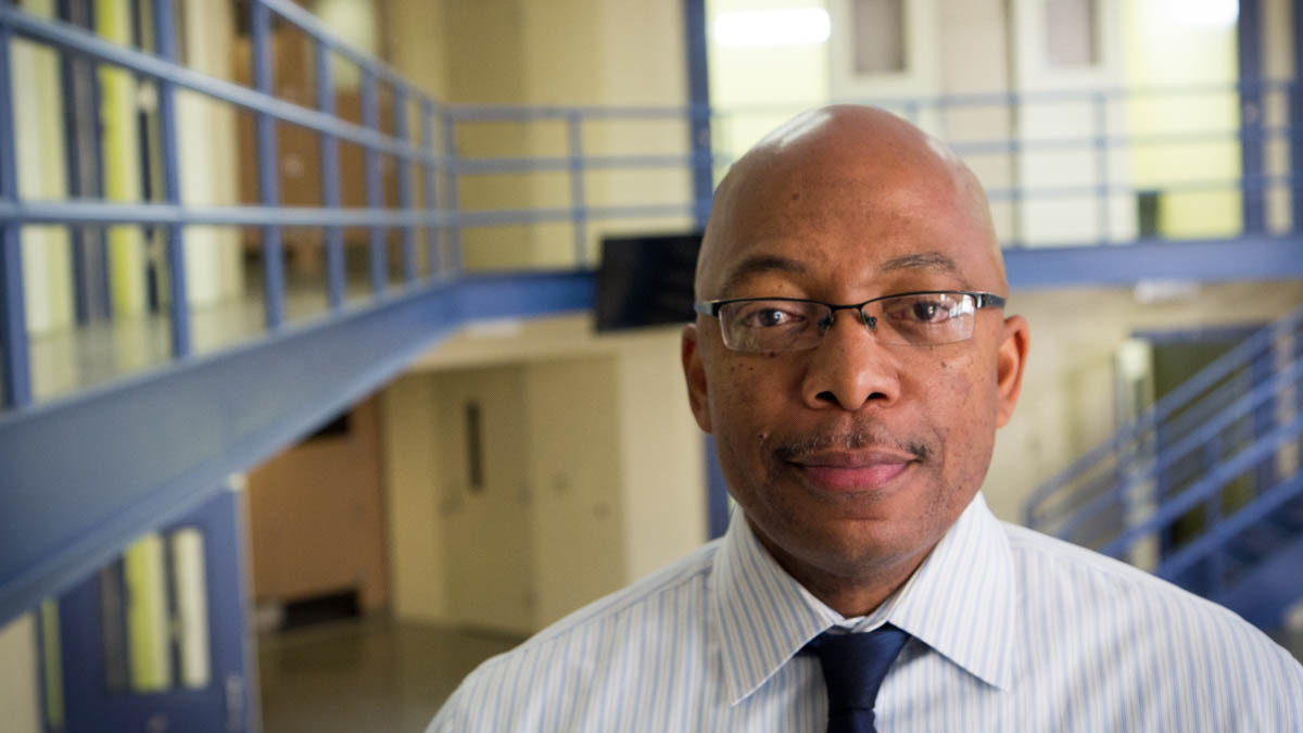 Brian Hopson, assistant superintendent at Alameda County Juvenile Hall, stands in one of its many empty units. The 360-bed facility was full when it opened eight years ago, but is now at half capacity. (Youth Radio)