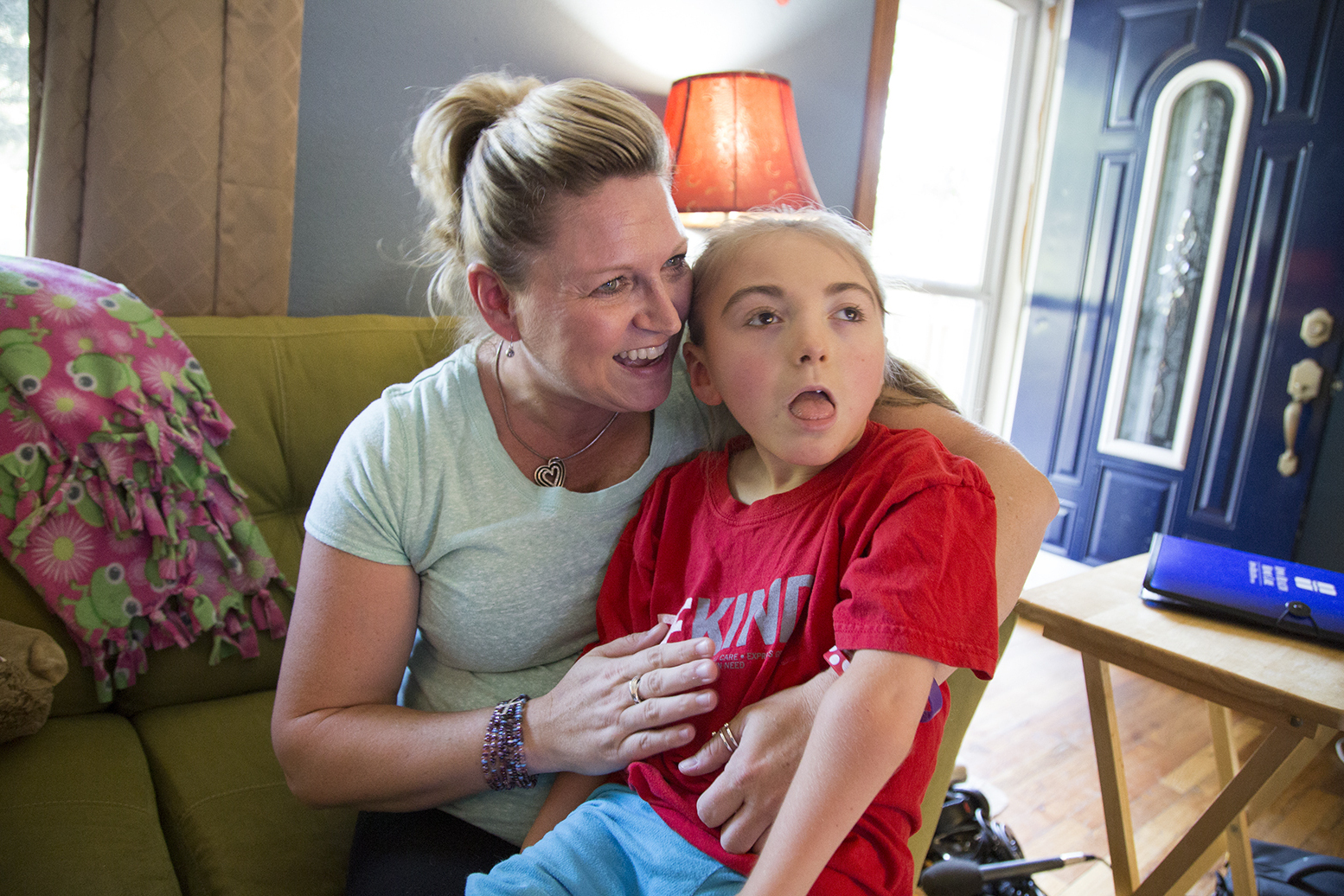 Brenda Hummel and her 7-year-old daughter Andrea in their home near Des Moines, Iowa. Andrea was born with severe epilepsy and gets her health care through Medicaid. (Clay Masters/Iowa Public Radio)