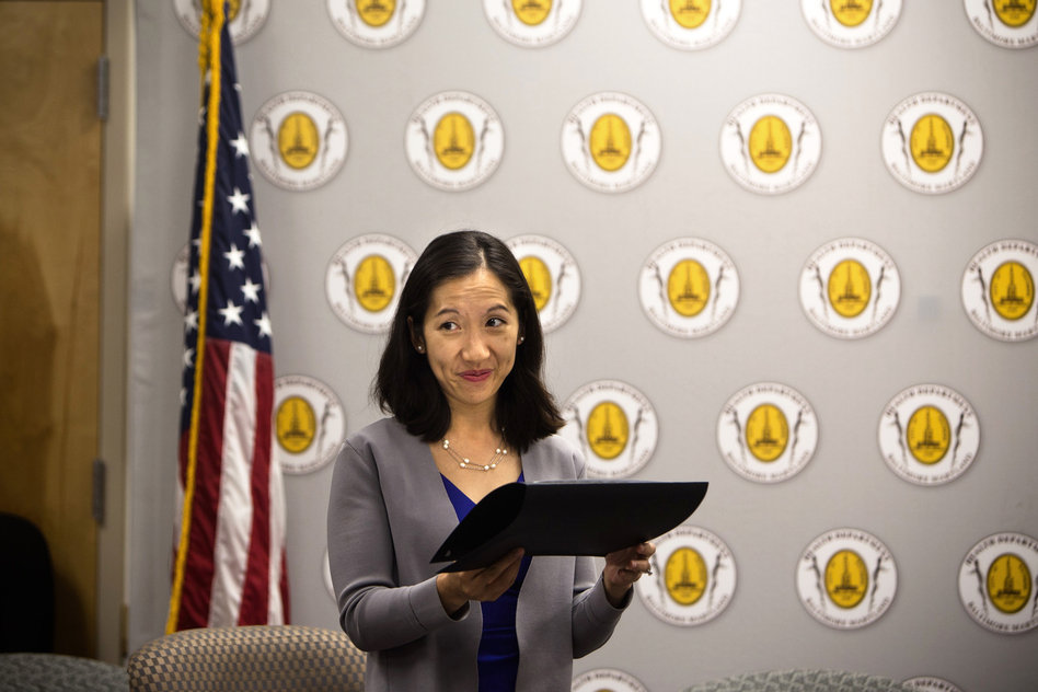 Leana Wen hands out awards to business owners for their efforts to support breastfeeding at the Baltimore City Health Department on Tuesday. (Meredith Rizzo/NPR)