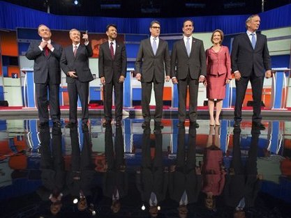 Republican presidential candidates from left, Jim Gilmore, Lindsey Graham, Bobby Jindal, Rick Perry, Rick Santorum, Carly Fiorina, and George Pataki take the stage for a pre-debate forum at the Quicken Loans Arena, Thursday, Aug. 6, 2015, in Cleveland. Seven of the candidates have not qualified for the primetime debate.