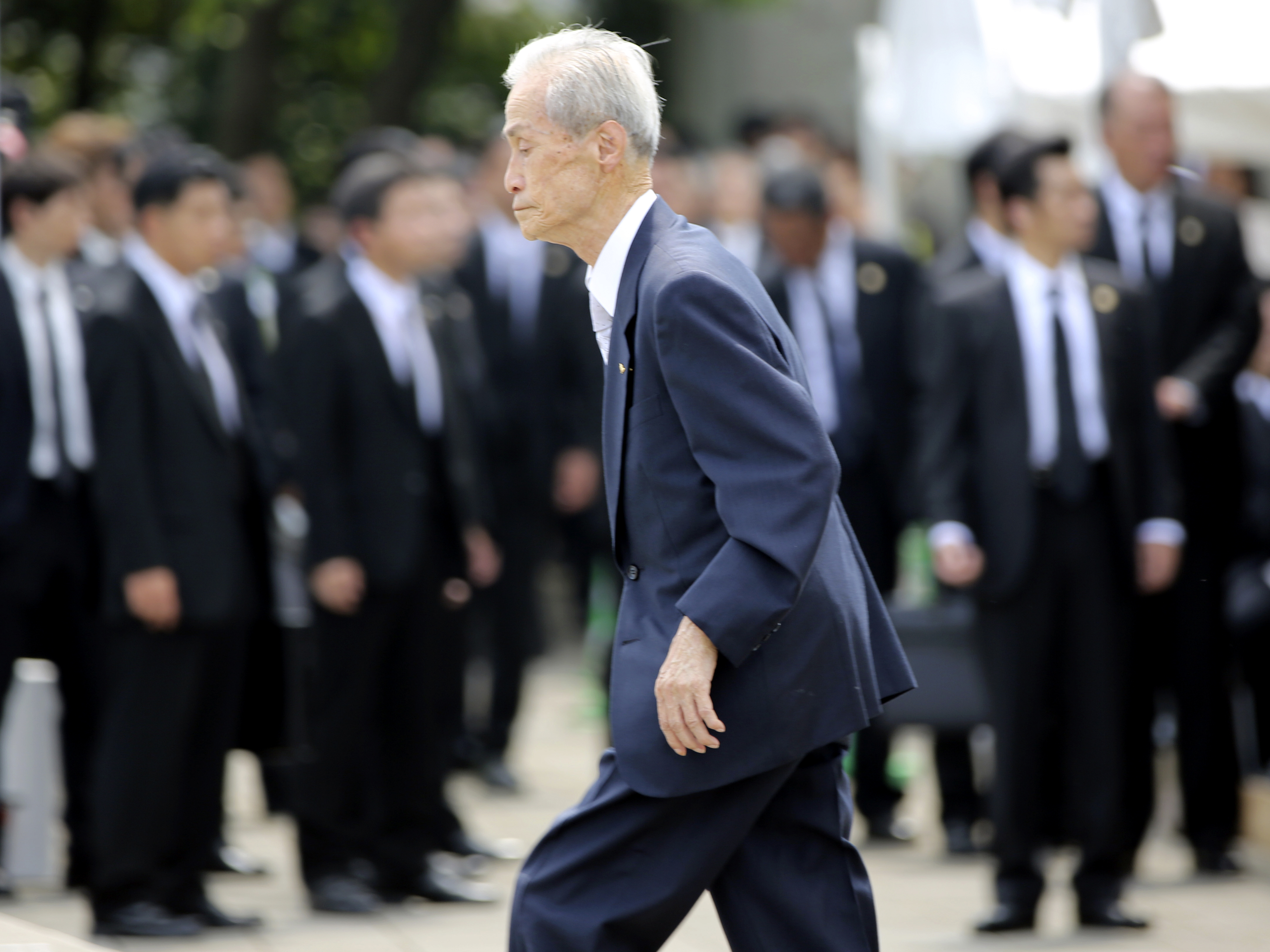 Sumiteru Taniguchi, 86, a survivor of the 1945 atomic bombing of Nagasaki, walks up to deliver his speech at the 70th anniversary of the atomic bombing in Nagasaki, southern Japan, on Sunday.