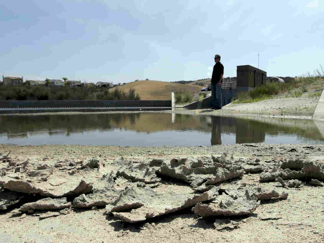 Rich Kissee, operations manager for the Santa Margarita Water District, stands on the edge of a water runoff reservoir in Rancho Santa Margarita, Calif.