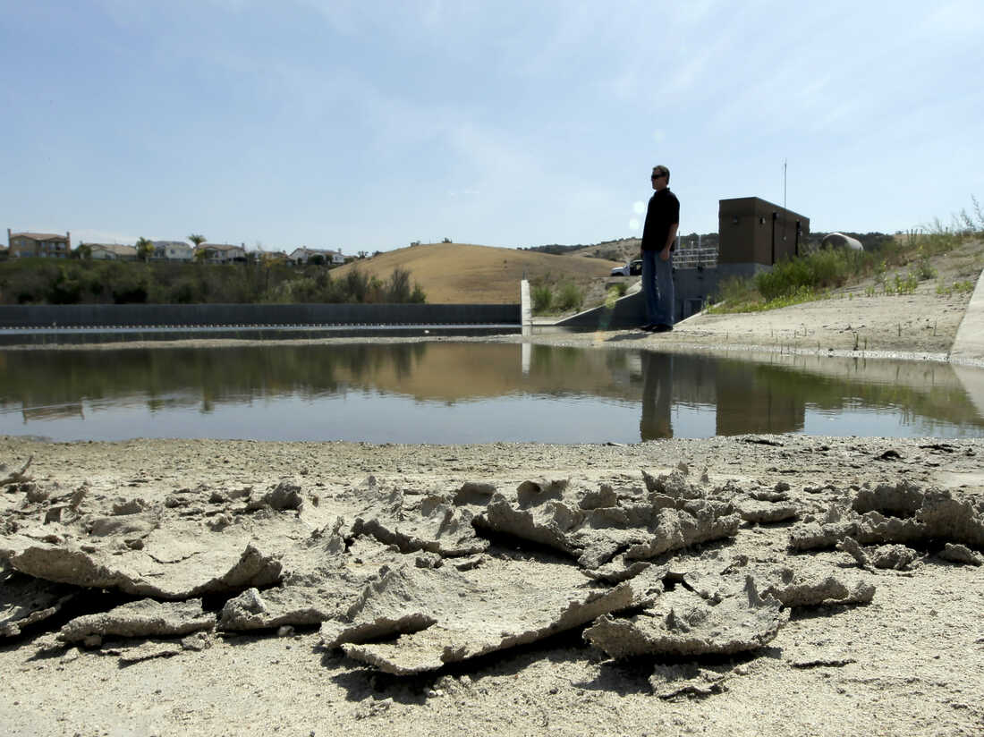 Rich Kissee, operations manager for the Santa Margarita Water District, stands on the edge of a water runoff reservoir in Rancho Santa Margarita, Calif.